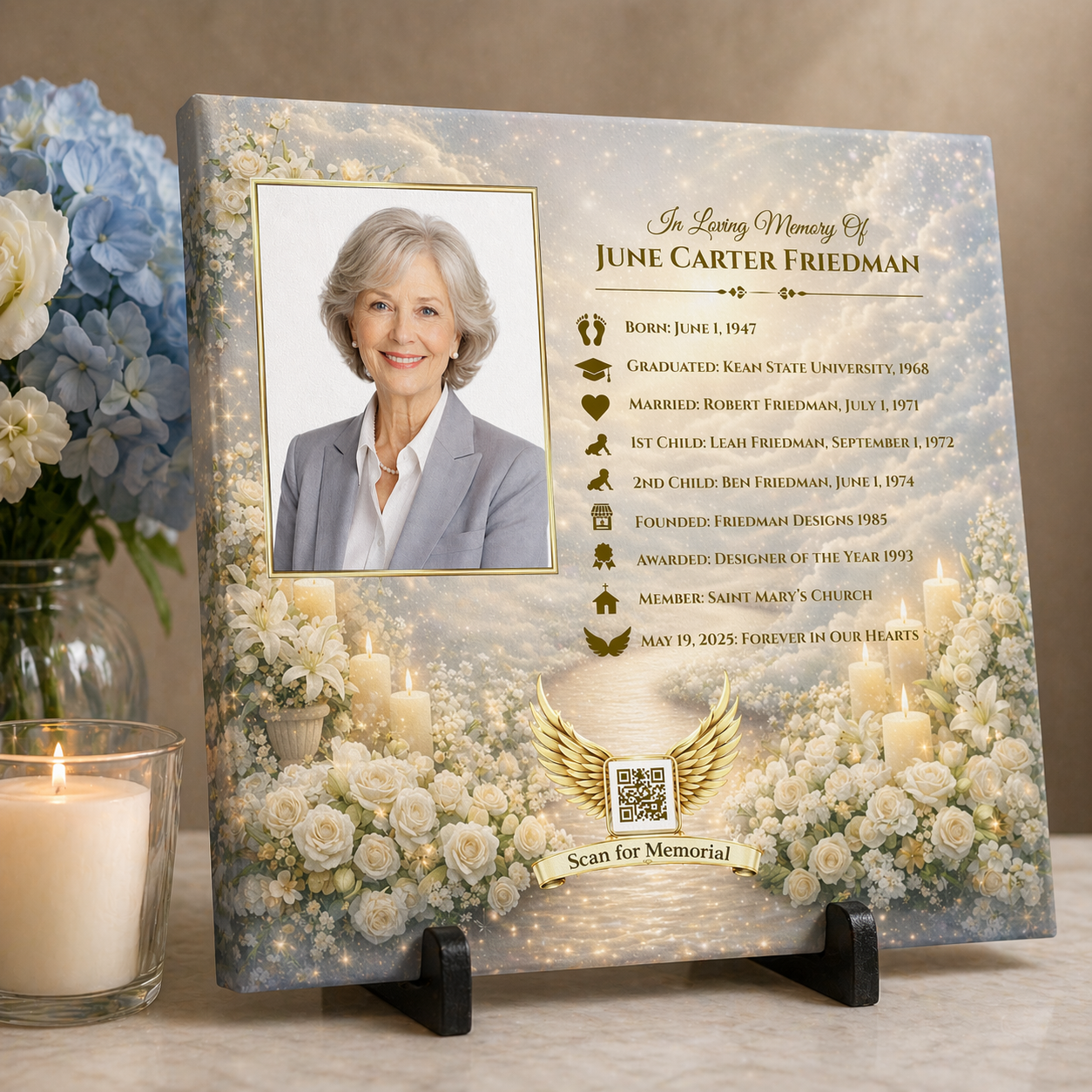 Memorial plaque with a photo of a woman, timeline, and floral design on a stand with a candle and flowers in the background.