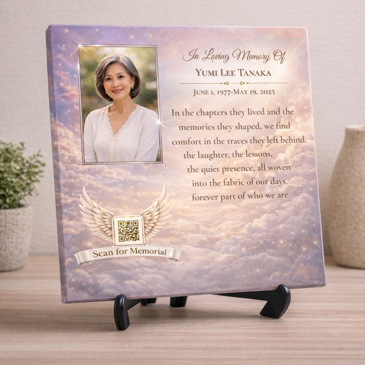 Memorial canvas featuring a woman's portrait, a quote, and a cloud background on a wall.